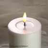 A close-up of a white LED candle with a realistic flame. Podgląd zdjęcia produktu