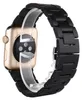 A close-up, studio shot of an Apple Watch with a black wooden band, displayed on a clear stand. Náhled obrázku produktu