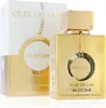 A gold perfume bottle and its packaging are displayed against a white background. Voir les images du produit