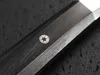 A close-up shot of a knife handle with a decorative silver inlay. Produktbild-Vorschau
