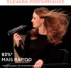 A woman is using a hairdryer on her hair, which is being blown by the airflow. Podgląd zdjęcia produktu
