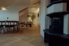 Interior view of a dining area and living space with a fireplace. Produktbild-Vorschau