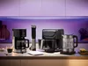 A collection of kitchen appliances displayed on a countertop with ambient lighting. Produktbild-Vorschau
