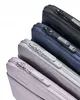 A close-up view of four laptop sleeves stacked diagonally against a white background. Produktbild-Vorschau