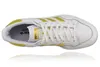 A top-down view of a white Adidas sneaker with yellow stripes and gold accents. Produktbild-Vorschau