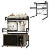 A black metal kitchen shelf unit holding a microwave, a rice cooker, and various kitchen accessories. Voir les images du produit