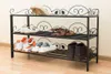 A three-tiered black metal shoe rack holding various shoes. Produktbild-Vorschau