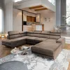 A modern living room with a large sectional sofa and a kitchen area in the background. Podgląd zdjęcia produktu