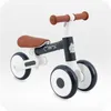 A children's balance bike with four wheels. Podgląd zdjęcia produktu