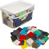 A clear studio shot of a clear plastic container filled with various colored plastic leveling shims, with a pile of shims scattered in front of the container. Produktbild-Vorschau