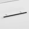 A close-up shot of a cabinet handle on a white surface. Produktbild-Vorschau