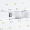 A close-up view of a white LED light strip with multiple LEDs visible, and a gray connector piece. Náhľad obrázku produktu