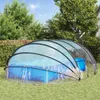 A transparent pool enclosure dome covering a blue swimming pool in a grassy backyard. Anteprima dell’immagine prodotto