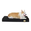 A corgi dog lying on a black dog bed. Náhľad obrázku produktu