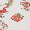A close-up view of a white fabric with a repeating pattern of cartoon-style Santas and gift boxes, rendered in red and green. Náhľad obrázku produktu