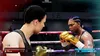 Two female boxers facing each other in a boxing ring during a match. Produktbild-Vorschau