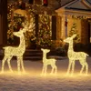 Three illuminated reindeer figures are displayed in the snow in front of a house decorated for Christmas. Produktbild-Vorschau
