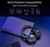 A pair of black gaming headphones rests on a laptop, with a smartphone visible in the foreground, all set against a dark, moody background. Náhled obrázku produktu