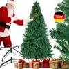 Santa Claus standing next to a Christmas tree with gifts at the base. Náhled obrázku produktu