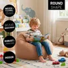 A young boy is reading a book while sitting on a beanbag chair in a child's room. Voir les images du produit