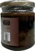 A jar of pine cone paste on a textured background. Podgląd zdjęcia produktu