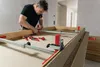 A man is using a door frame tensioner to assemble a door frame. Anteprima dell’immagine prodotto