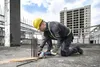 A construction worker is using an angle grinder to cut rebar on a construction site. Náhľad obrázku produktu