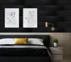 A bedroom scene with a bed, artwork, and a nightstand. Anteprima dell’immagine prodotto