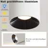 A close-up of a white cylindrical LED ceiling light with a black interior, showing its features and materials. Produktbild-Vorschau