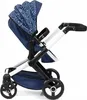A side view of a blue and white patterned doll stroller on a white background. Produktbild-Vorschau