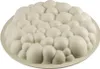 A white silicone cake mold with a bubble-like texture, placed on a white plate. Anteprima dell’immagine prodotto