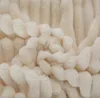 A close-up view of a textured, cream-colored blanket. Podgląd zdjęcia produktu