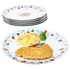 A stack of Christmas-themed plates and one plate with food. Náhled obrázku produktu