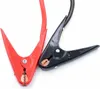Close-up of two jumper cable clamps, one red and one black, on a white background. Náhled obrázku produktu