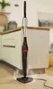 A steam mop is shown in a kitchen setting, with steam emanating from its base. Produktbild-Vorschau