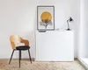 A minimalist room with a chair, a white cabinet, and a framed picture on the wall. Produktbild-Vorschau