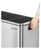 A hand is shown opening a lid on a stainless steel trash can with multiple compartments. Náhľad obrázku produktu