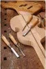 Woodworking tools and unfinished guitar bodies on a workbench. Anteprima dell’immagine prodotto