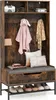 A rustic-style hall tree with a bench, storage compartments, hooks, and a shoe rack, decorated with a pink hooded towel, a scarf, and pillows. Podgląd zdjęcia produktu