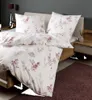 A neatly made bed with floral patterned bedding in a bedroom setting. Produktbild-Vorschau