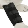 A close-up view of a black dog leg brace on a white dog's leg. Voir les images du produit