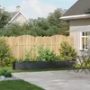 A backyard scene with a raised planter, fence, and patio furniture. Anteprima dell’immagine prodotto