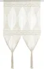 A macrame curtain hanging against a white background. Náhľad obrázku produktu