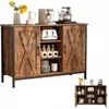 A rustic-style sideboard with sliding barn doors, displaying kitchenware and appliances on its top surface and within its shelves. Náhľad obrázku produktu