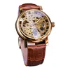 A close-up studio shot of a men's automatic skeleton watch with a gold-tone case and a brown leather strap. Produktbild-Vorschau