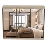 A reflection of a bedroom scene in a mirrored wardrobe. Voir les images du produit