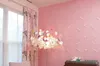 A child's bedroom with pink walls, a large window with pink curtains, a floor lamp with petal-like shades, and decorative dragonflies on the wall. Produktbild-Vorschau