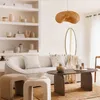 A cozy living room scene with a sofa, coffee table, and decorative items. Podgląd zdjęcia produktu