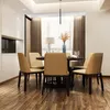 A dining room setting with a round table and chairs, illuminated by a pendant light. Podgląd zdjęcia produktu