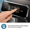 A hand is shown interacting with the touchscreen display of a coffee machine. Produktbild-Vorschau